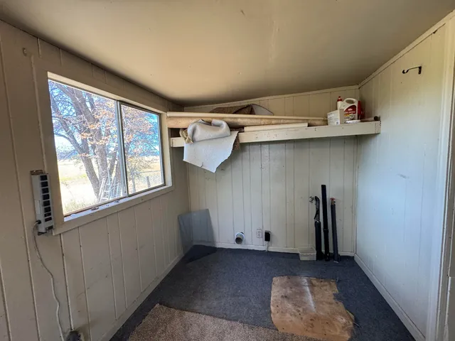 a front view of a house with a yard covered in snow