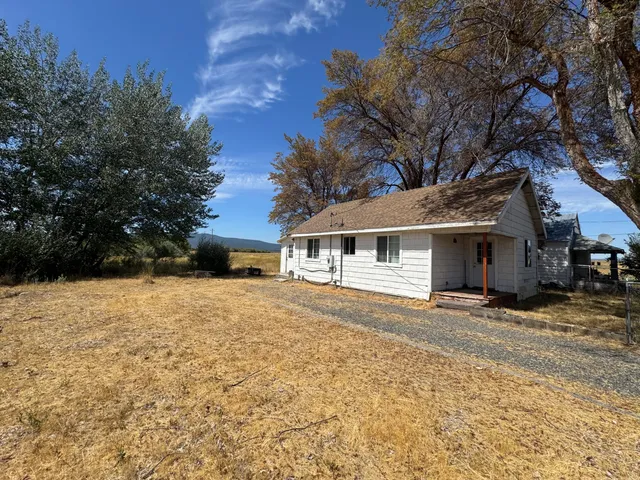 a front view of a house with a yard covered in snow