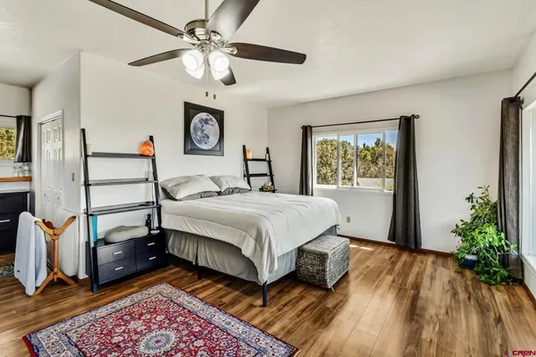 a bedroom with a bed dresser and a window