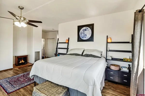a bedroom with a bed and a lamp with the dresser