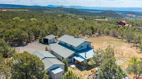 an aerial view of a house with a yard