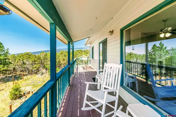 a view of a city from a balcony with furniture