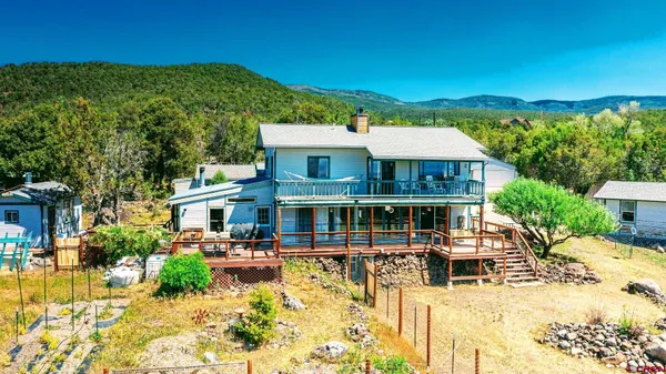 a view of a house with swimming pool and sitting area