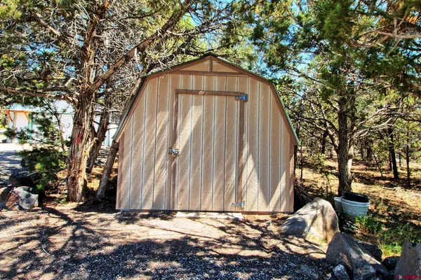 a view of a yard with large trees