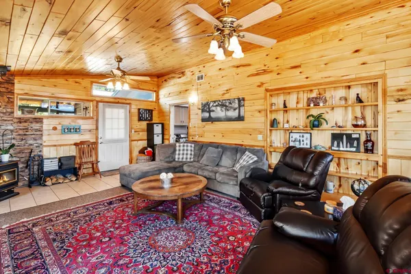 a living room with furniture a rug and a table