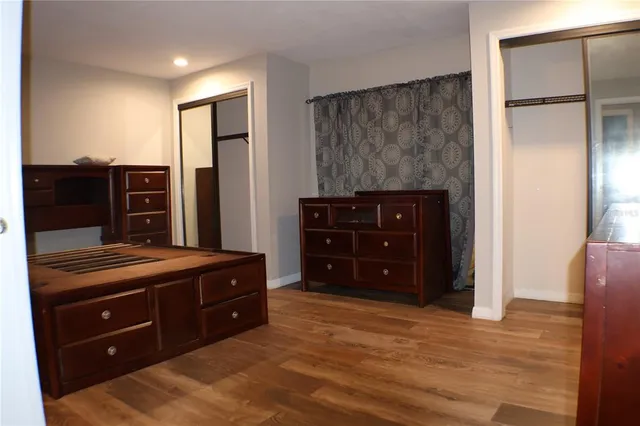 a view of kitchen with granite countertop cabinets and window