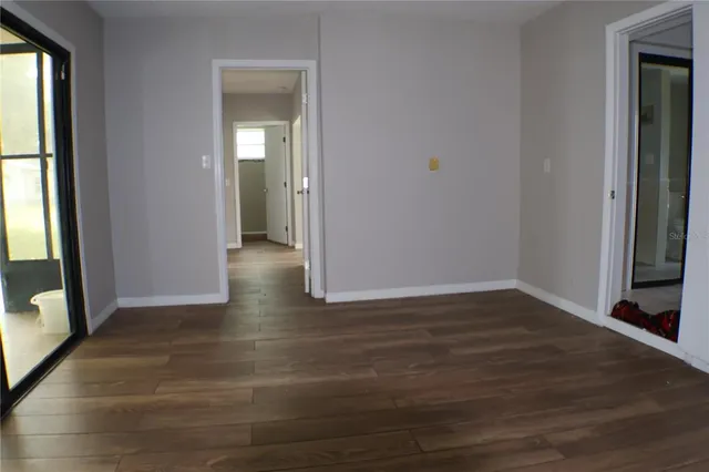a view of hallway with wooden floor