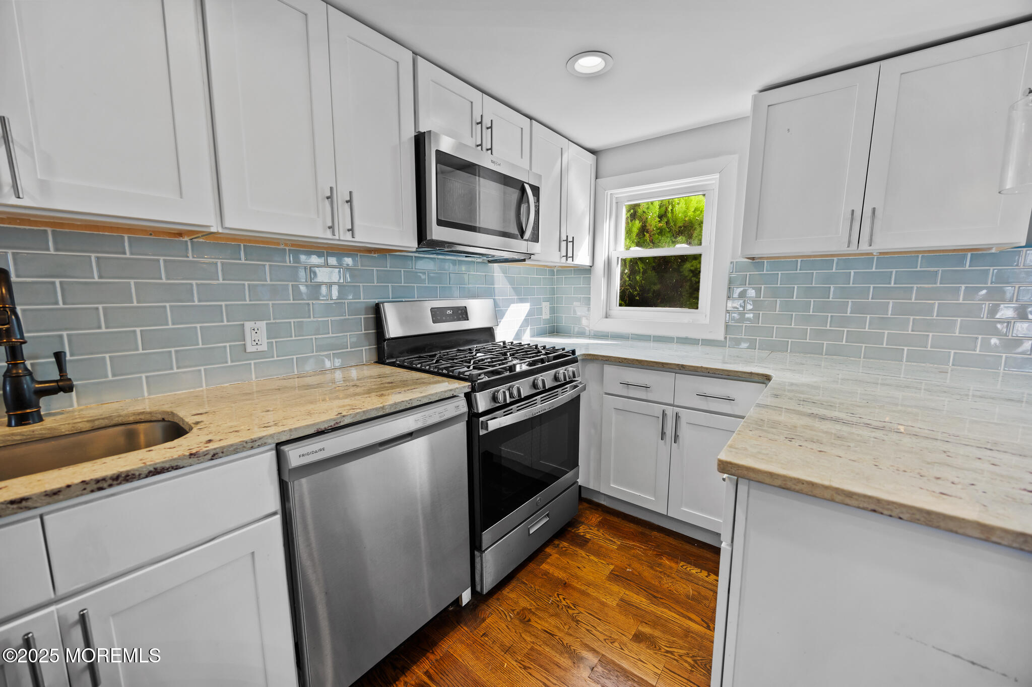 605 Ocean Gate Avenue Ocean Gate, NJ 08740 - Photo 16 of 45 a kitchen with stainless steel appliances granite countertop white cabinets a stove top oven a sink and dishwasher