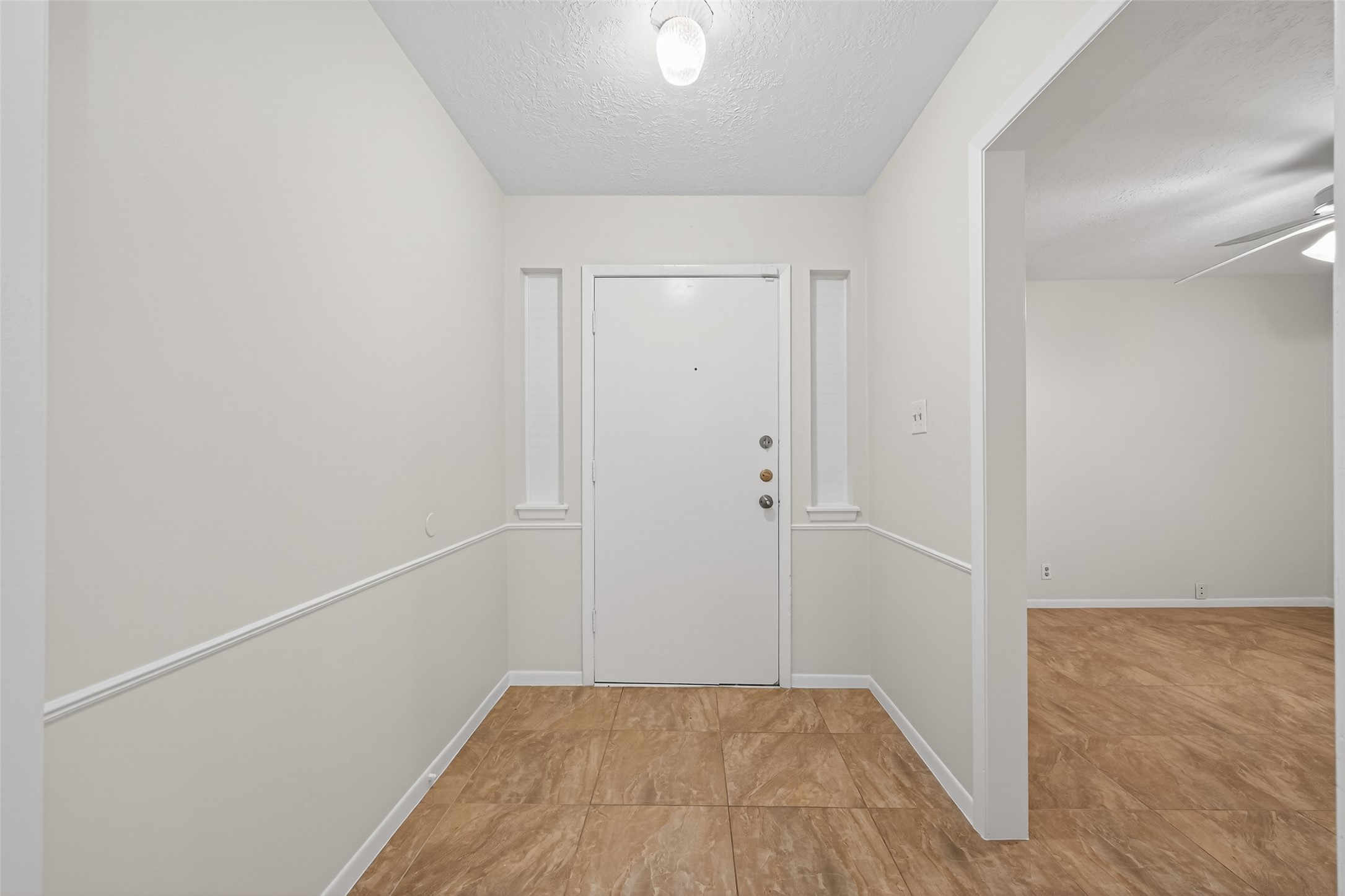 23919 Farm Hill Drive Spring, TX 77373 - Photo 6 of 41 a view of a room with wooden floor and white walls