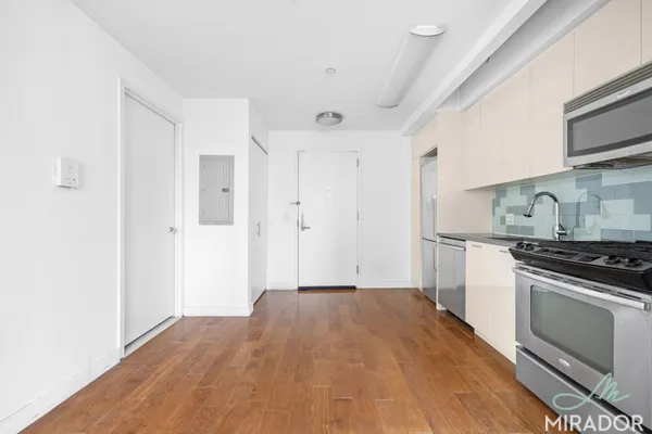 a kitchen with a stove and white cabinets