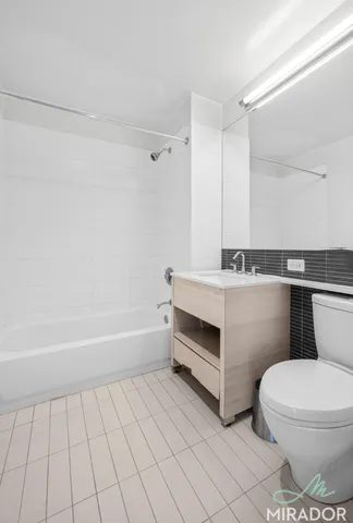 a bathroom with a sink a toilet and bathtub