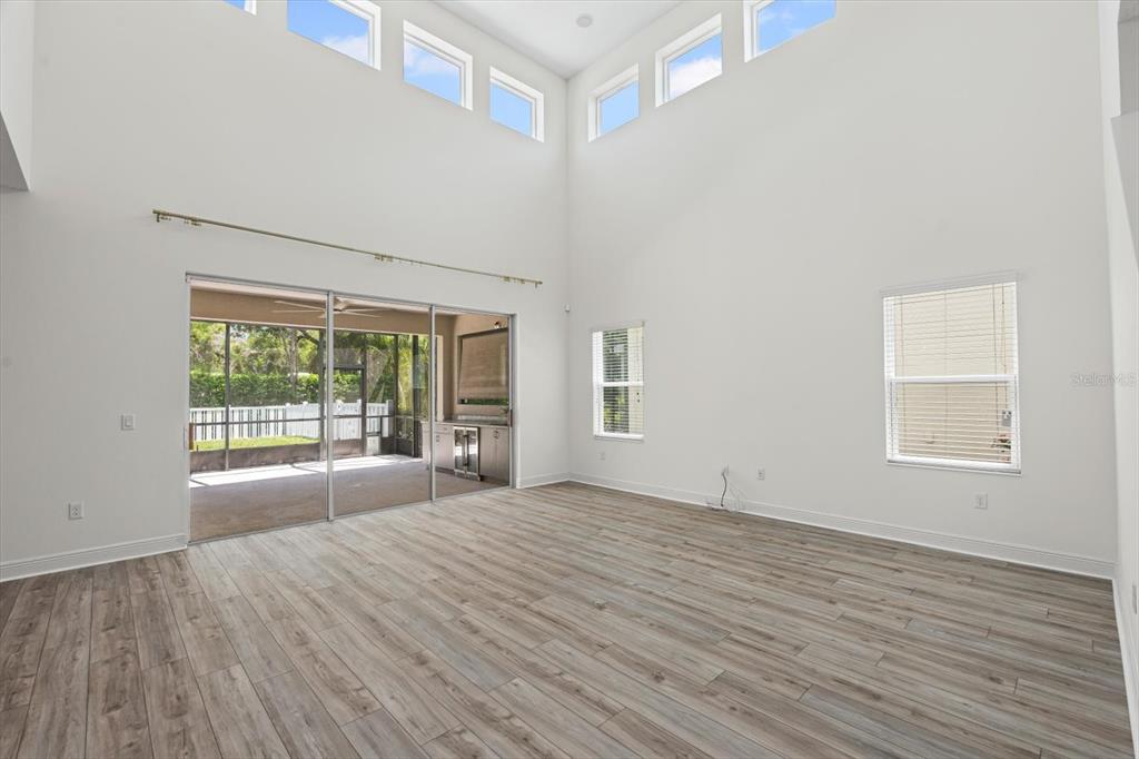 4457 Sage Grn Terrace Sarasota, FL 34243 - Photo 11 of 51 a view of an empty room with a window and wooden floor