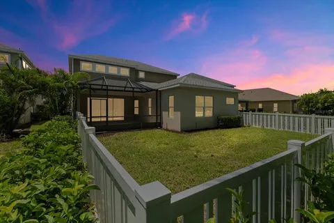 a view of a house with a backyard