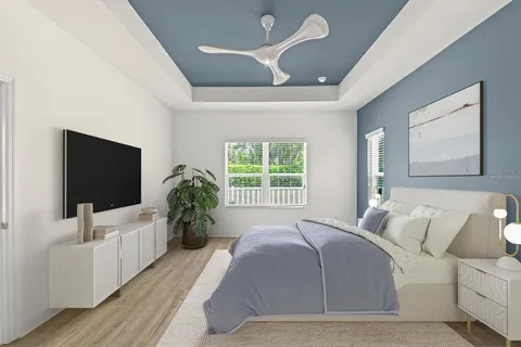 a bedroom with a large bed and a flat screen tv