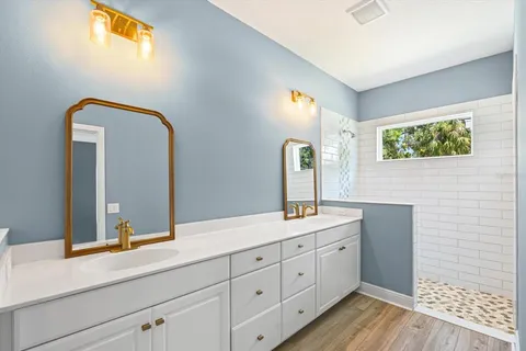 a bathroom with a double vanity sink and mirror