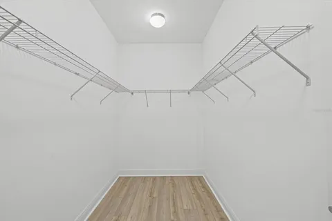 a view of an empty room and wooden floor