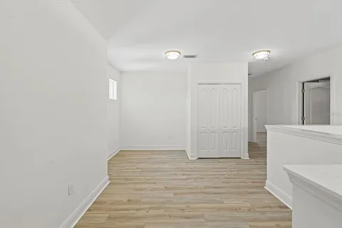 a view of an empty room and wooden floor