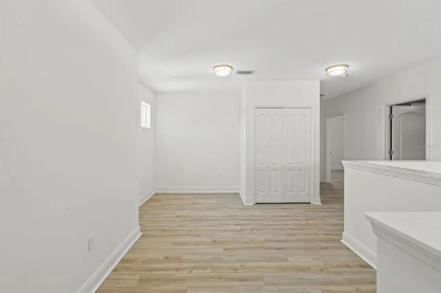 a view of an empty room and wooden floor