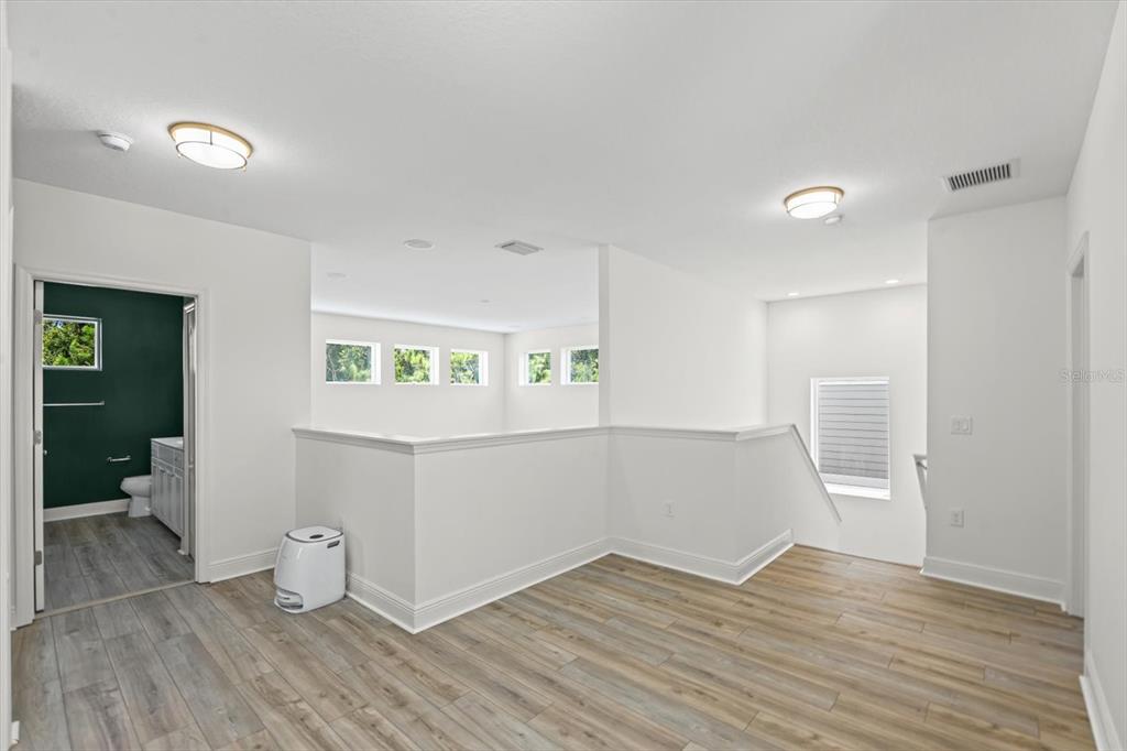 4457 Sage Grn Terrace Sarasota, FL 34243 - Photo 35 of 51 a view of an empty room and wooden floor