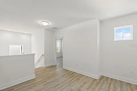 a workspace with wooden floor and windows