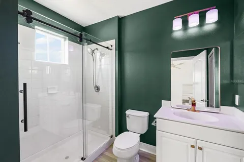 a bathroom with a sink a toilet and shower