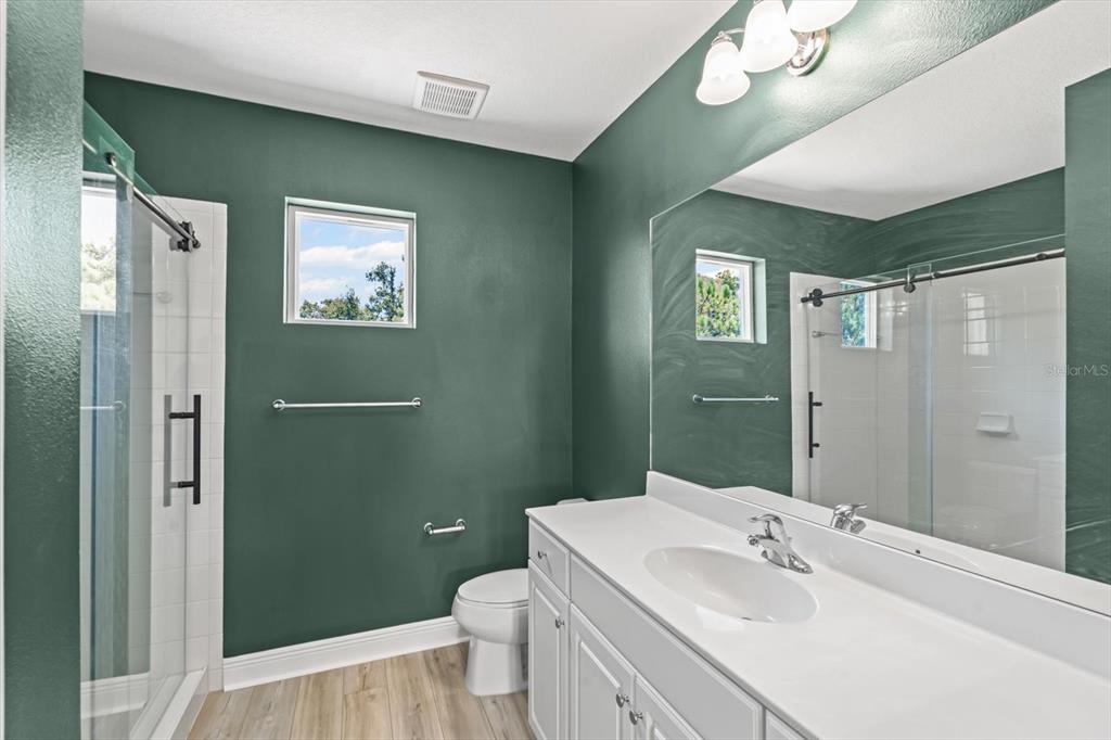 4457 Sage Grn Terrace Sarasota, FL 34243 - Photo 40 of 51 a bathroom with a sink a toilet and shower