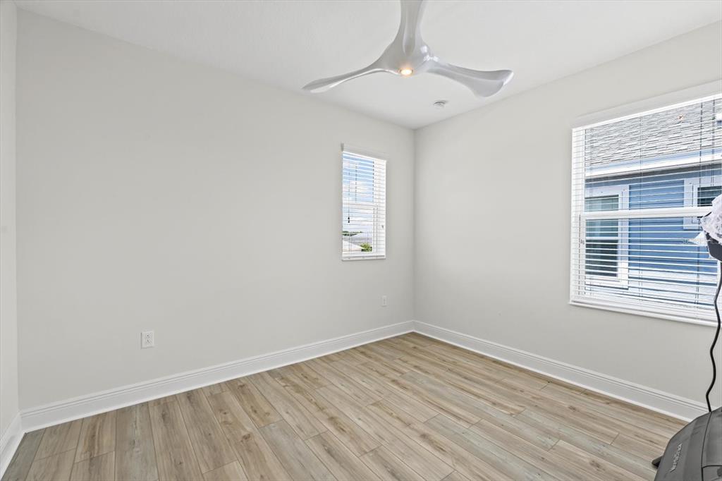 4457 Sage Grn Terrace Sarasota, FL 34243 - Photo 41 of 51 wooden floor in an empty room with a window