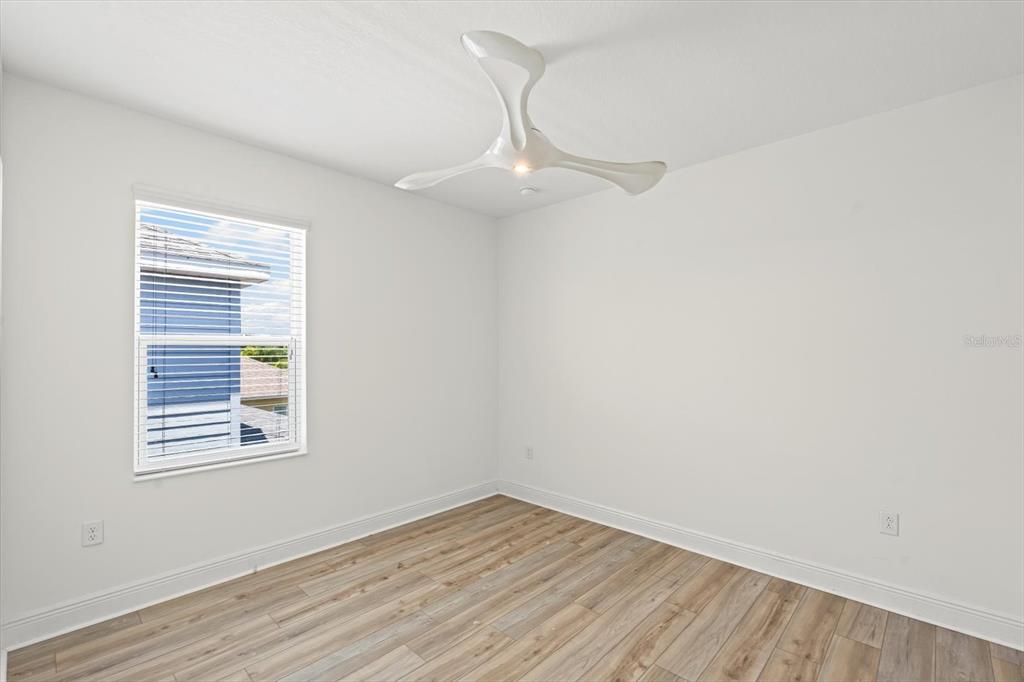 4457 Sage Grn Terrace Sarasota, FL 34243 - Photo 42 of 51 wooden floor in an empty room with a window