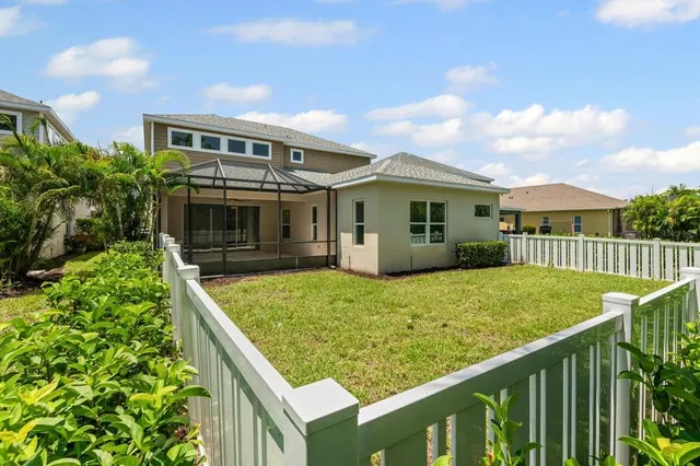 a view of house with backyard