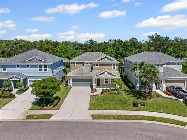 an aerial view of residential house with outdoor space and parking