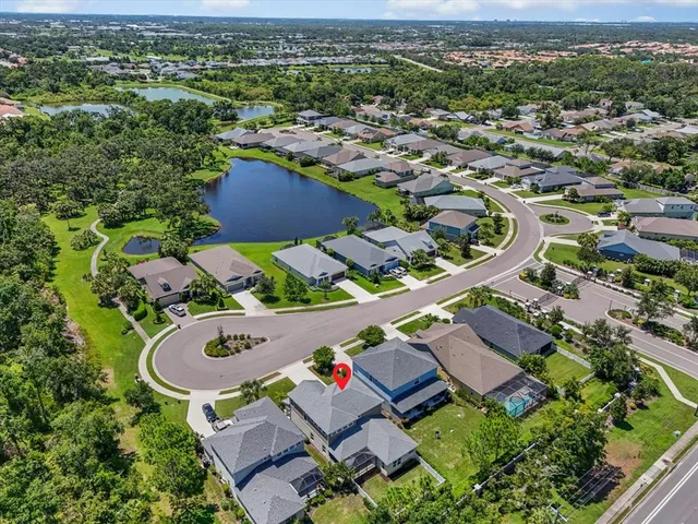 an aerial view of residential houses with outdoor space