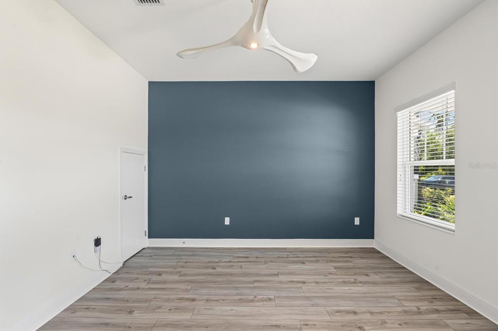 4457 Sage Grn Terrace Sarasota, FL 34243 - Photo 9 of 51 an empty room with wooden floor and windows
