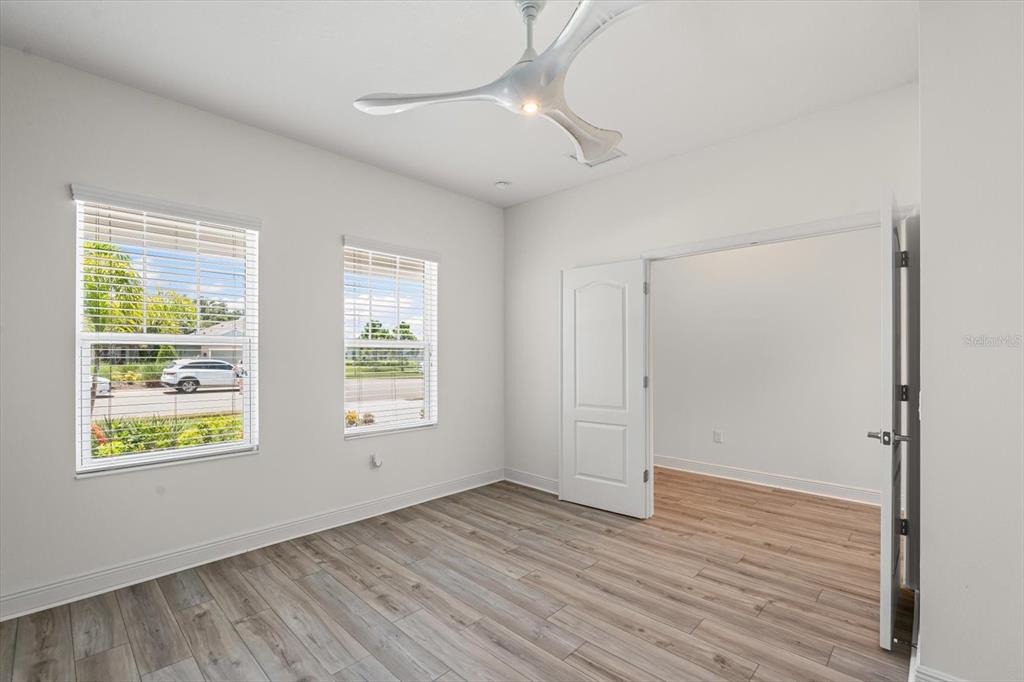 4457 Sage Grn Terrace Sarasota, FL 34243 - Photo 10 of 51 a view of an empty room with wooden floor and a window