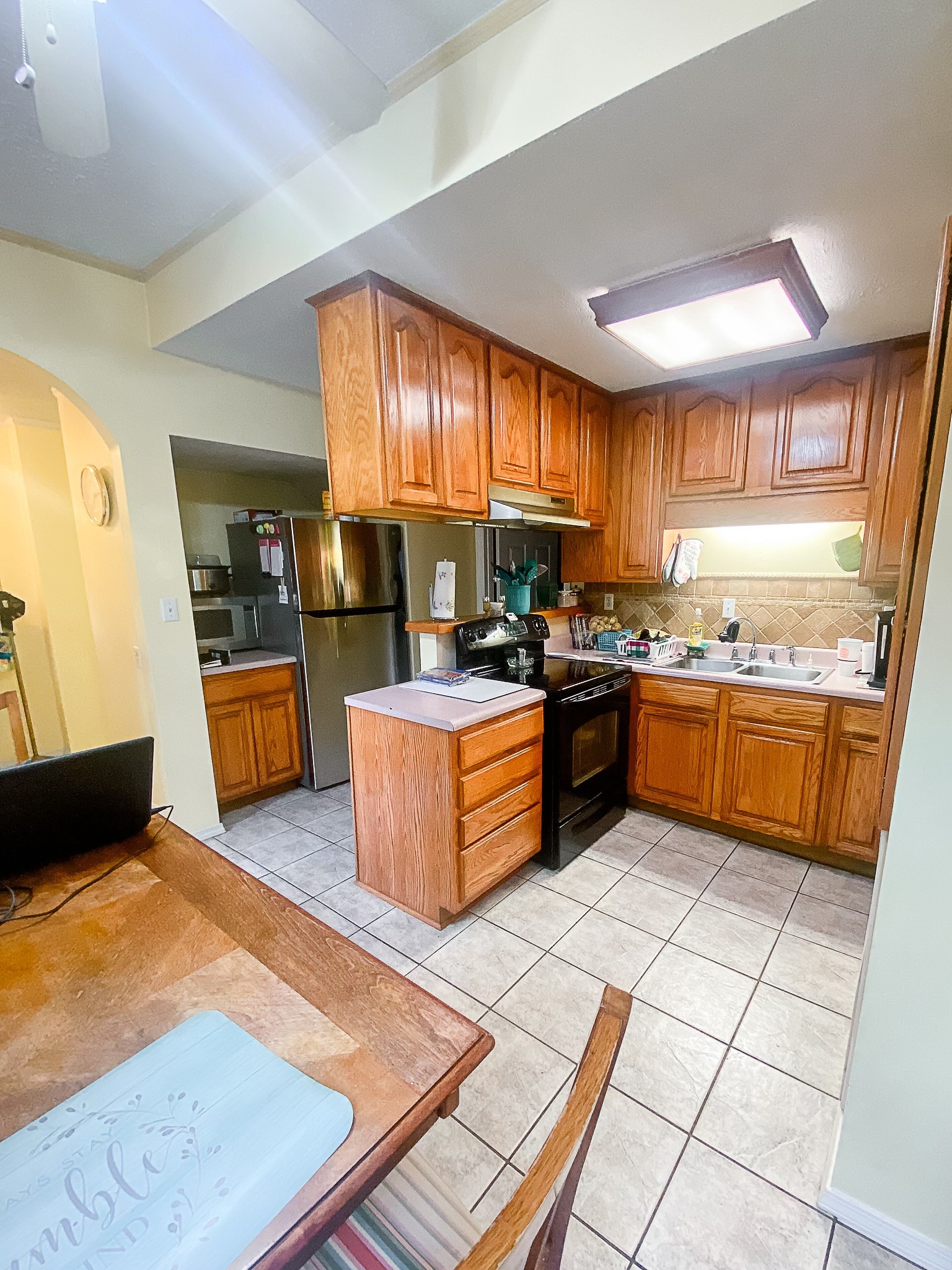 1885 Luther Sharp Road Columbia, TN 38401 - Photo 19 of 24 a kitchen with stainless steel appliances kitchen island granite countertop wooden cabinets a stove a sink and a large window