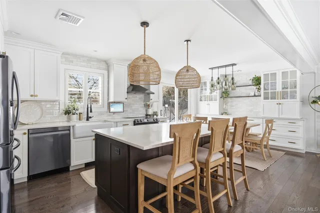 a kitchen with stainless steel appliances a sink stove and cabinets