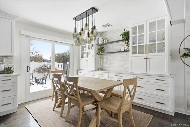 a view of a dining room with furniture and chandelier