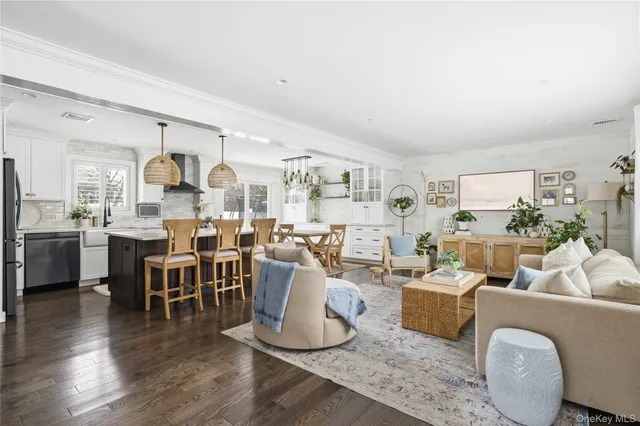 a living room with lots of furniture and kitchen view