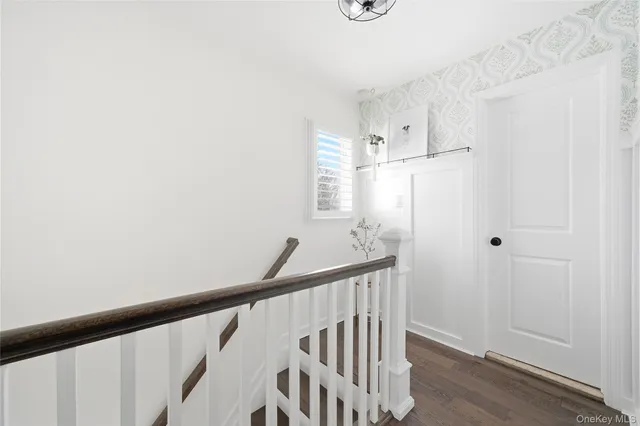 a view of a hallway with wooden floor and entryway