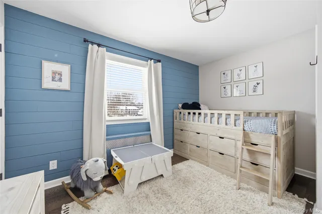 a bedroom with furniture and a window