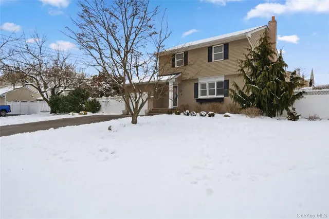 a view of house with a yard covered in snow