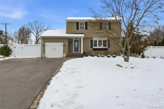 a view of house with snow on the road