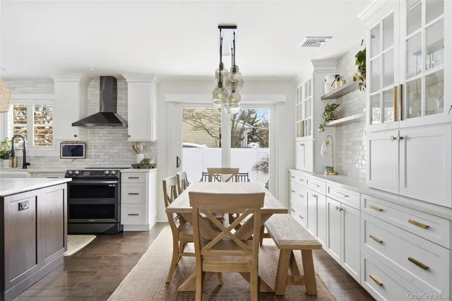 a kitchen with stainless steel appliances granite countertop a stove and white cabinets