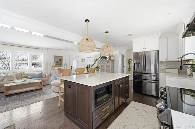 a kitchen with stainless steel appliances granite countertop a sink a stove and a refrigerator