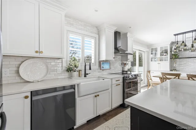a kitchen with stainless steel appliances granite countertop a sink stove and cabinets