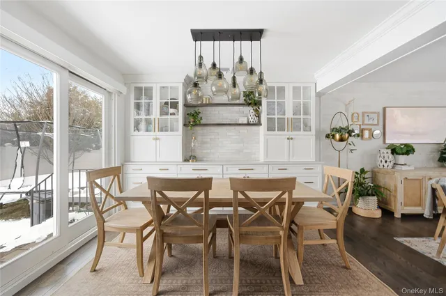 a view of a dining room with furniture a chandelier and wooden floor