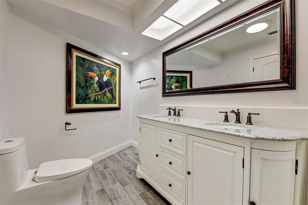 1875 Belleair Road Clearwater, FL 33764 - Photo 52 of 100 a bathroom with a toilet a sink and mirror