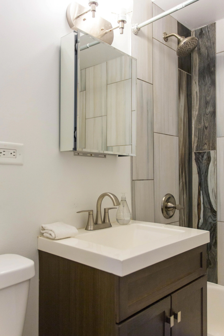 4136 West Palmer Street Chicago, IL 60639 - Photo 17 of 35 a bathroom with a sink a toilet and shower