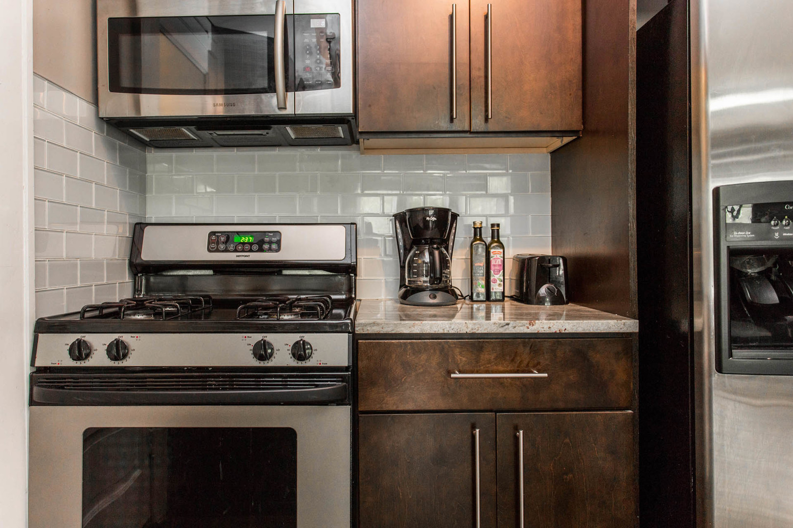 4136 West Palmer Street Chicago, IL 60639 - Photo 24 of 35 a stove top oven sitting inside of a kitchen and stainless steel appliances