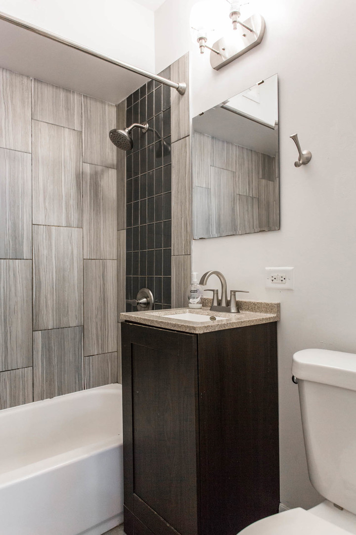 4136 West Palmer Street Chicago, IL 60639 - Photo 25 of 35 a bathroom with a sink a toilet and shower