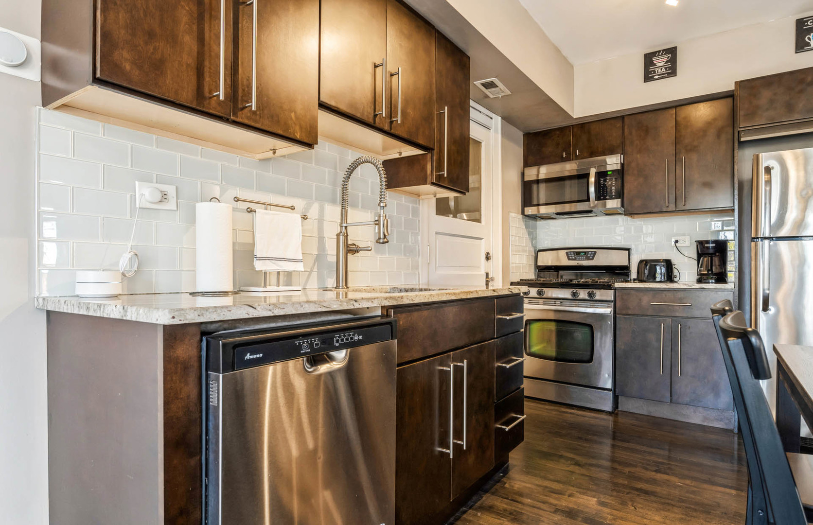 4136 West Palmer Street Chicago, IL 60639 - Photo 6 of 35 a kitchen with stainless steel appliances granite countertop a refrigerator and a stove top oven
